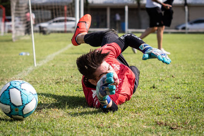 People playing soccer ball on field