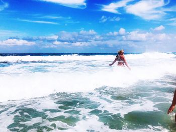 Man surfing in sea against sky