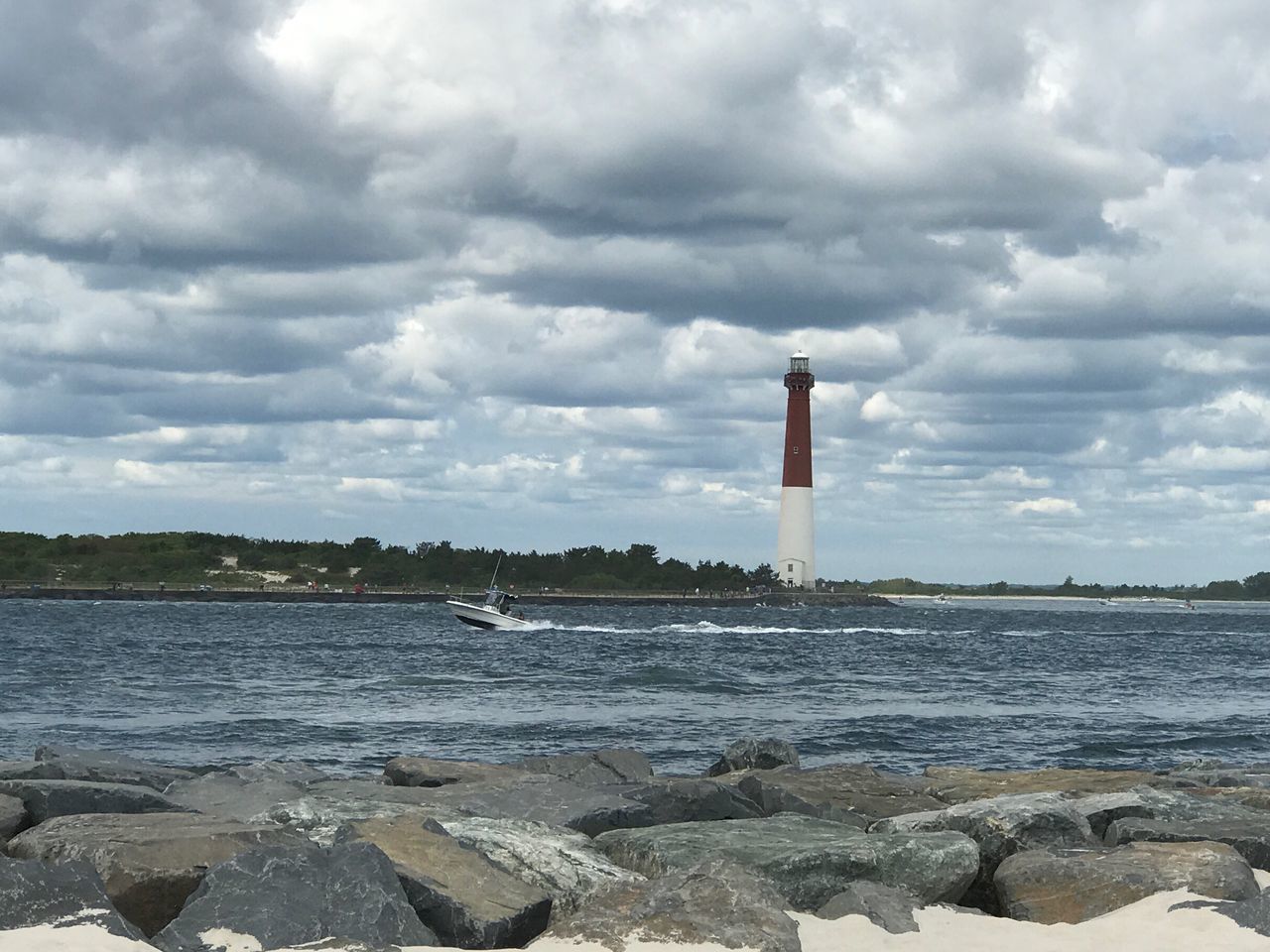 LIGHTHOUSE AT SEA AGAINST SKY