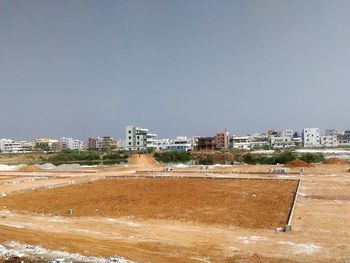 Buildings in town against clear sky