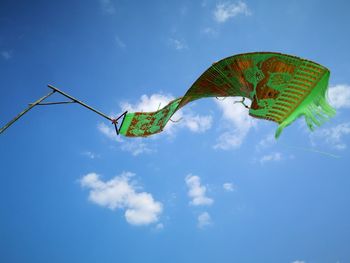Low angle view of kite flying against blue sky