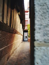 Alley amidst buildings against wall