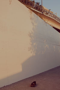 Low angle view of wall and bridge against sky