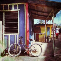 Bicycle parked by window of house