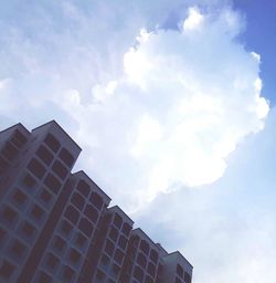 Low angle view of building against cloudy sky