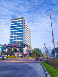 City street by buildings against sky