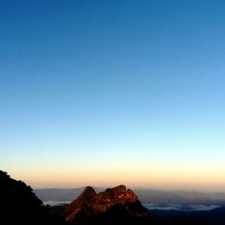 Scenic view of mountains against blue sky