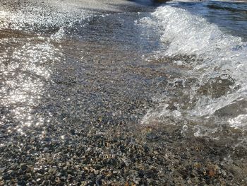 High angle view of waves splashing on shore