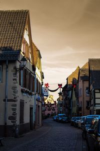 Street amidst buildings in city against sky