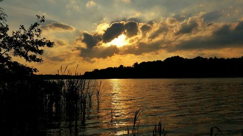 Scenic view of river at sunset