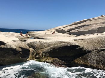 Scenic view of beach against clear blue sky