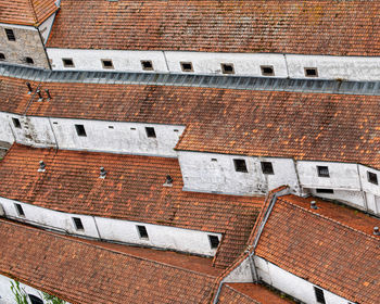 Background of old long white buildings with red tiled roofs. portugal urban background