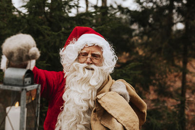 Man wearing santa costume carrying sack