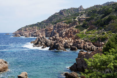 Scenic view of sea and mountains against sky