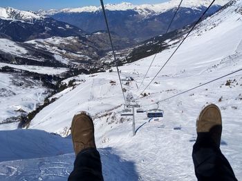 Low section of person on snowcapped mountain