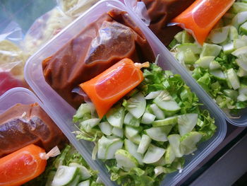 High angle view of salad in plastic containers