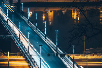 Light trails on bridge in city at night