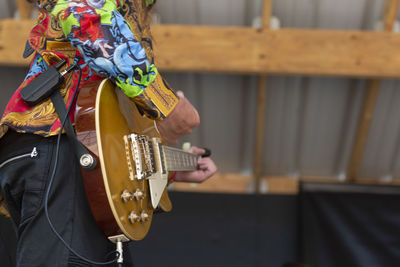 Midsection of person playing guitar