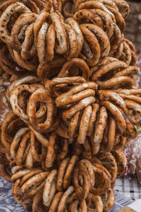 Tasty bagels with poppy on rope at the market stall