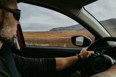 Man driving a car through iceland