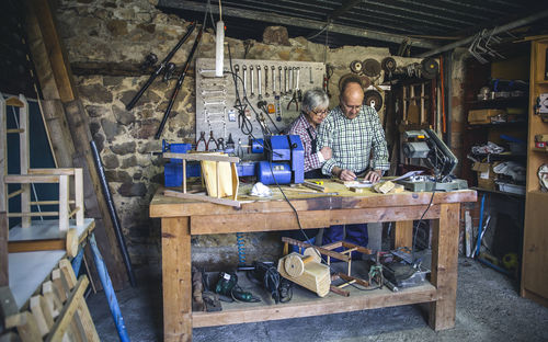 Senior couple working in workshop