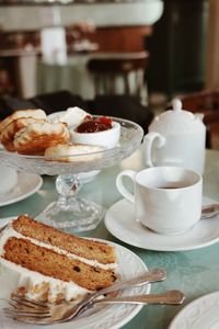 Close-up of cake and scones on table