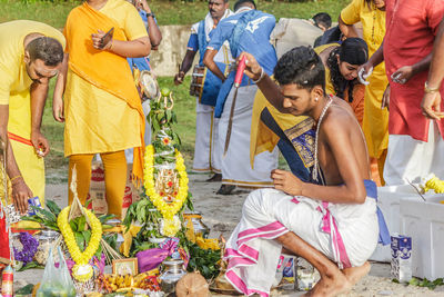 Rear view of people sitting in traditional clothing