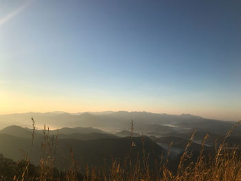 Scenic view of mountains against clear sky during sunset