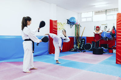 Rear view of people standing in corridor