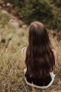 Rear view of woman on field