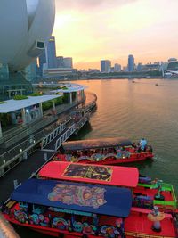 High angle view of city by river during sunset