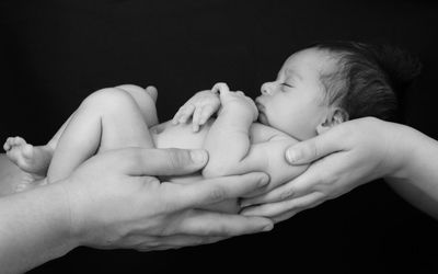 Close-up of hands holding baby boy