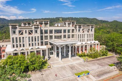 High angle view of buildings against cloudy sky