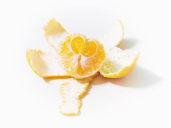 Close-up of lemon slice over white background