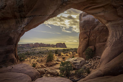 Scenic view of landscape against cloudy sky