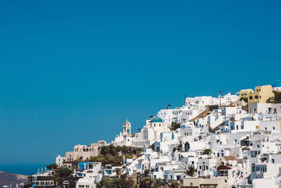 Cityscape against clear blue sky