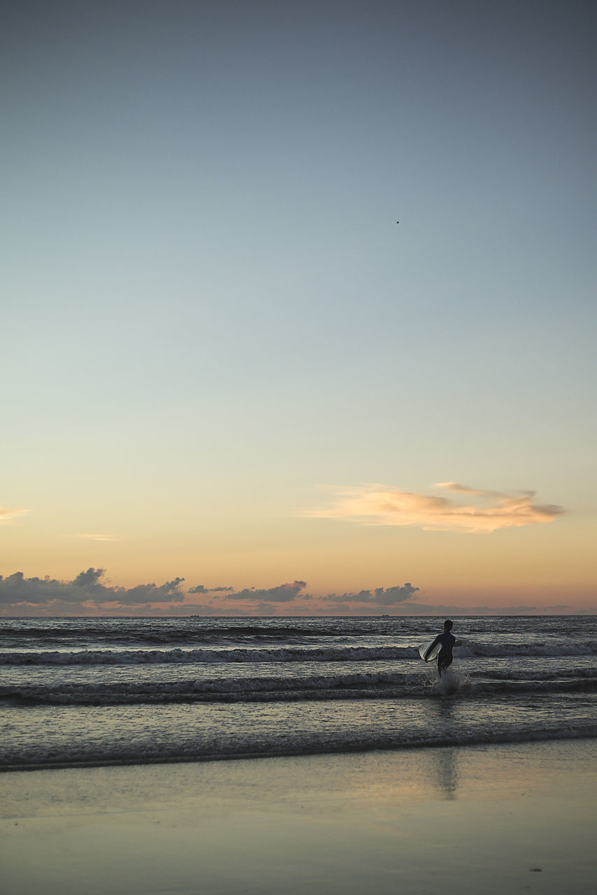 sky, sunset, water, sea, scenics - nature, beauty in nature, beach, land, tranquility, real people, tranquil scene, nature, silhouette, one person, horizon, horizon over water, orange color, idyllic, leisure activity, outdoors