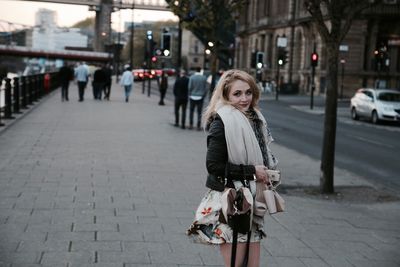 Young woman standing on city street