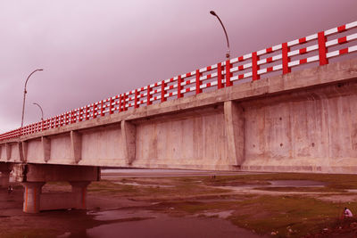 Bridge over street against sky