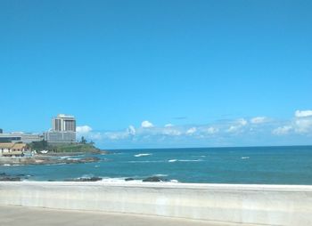 Scenic view of sea against sky in city