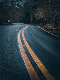 Road by trees in city