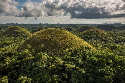 Scenic view of green landscape against sky