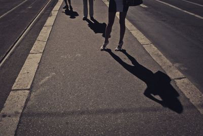 Low section of people walking on road