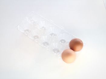 Close-up of eggs over white background