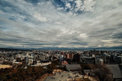 Cityscape against cloudy sky