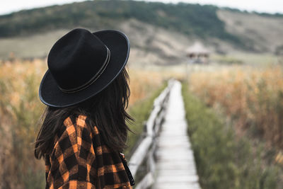 Side view of woman standing by land