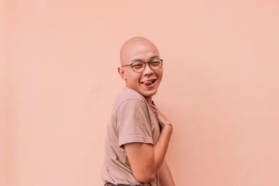 Portrait of smiling boy against wall
