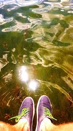 Low section of man standing in water