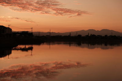 Scenic view of lake against romantic sky at sunrise