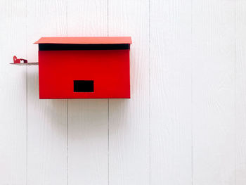 Close-up of red door with text on wall